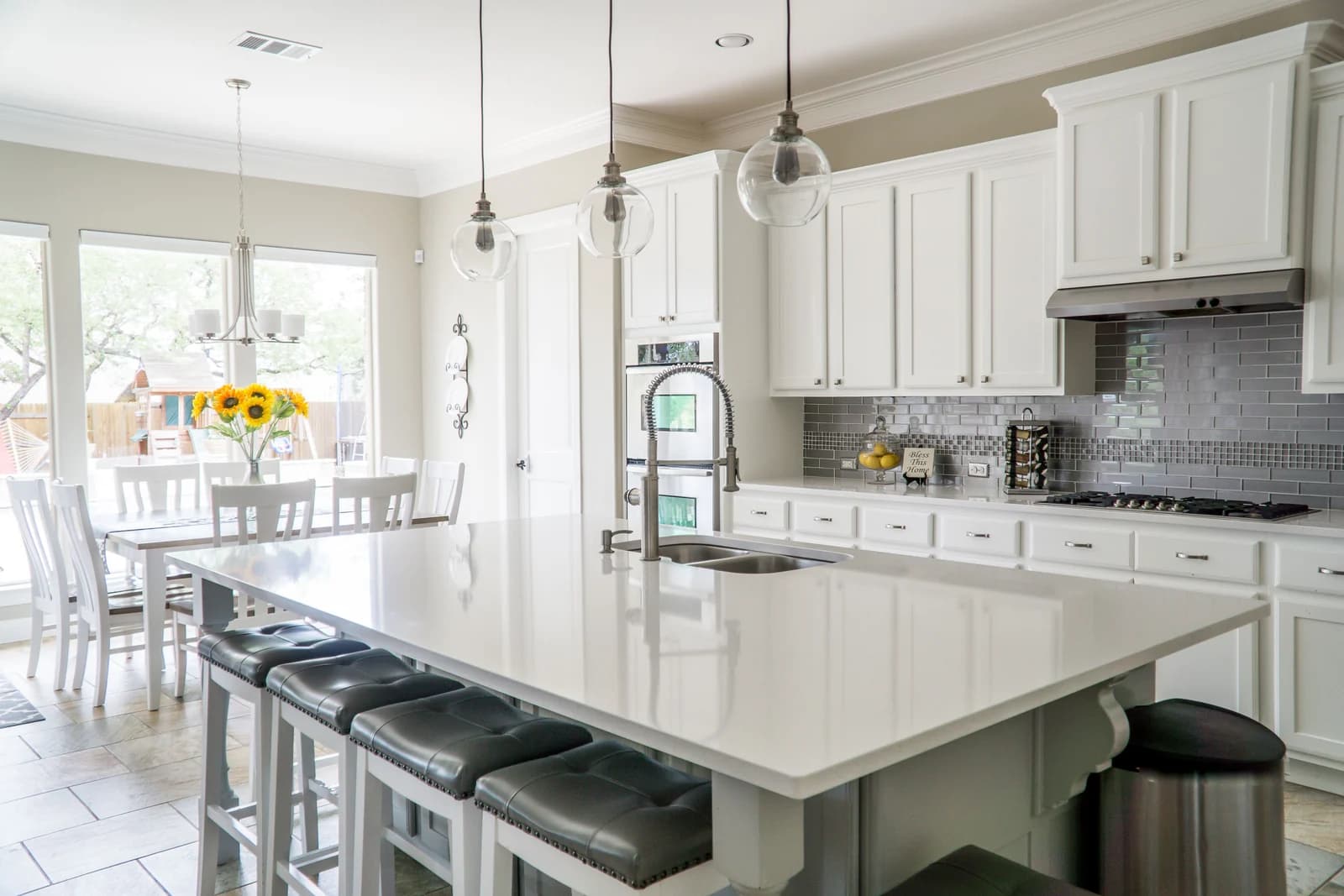 A bright kitchen with white cabinetry and natural light
